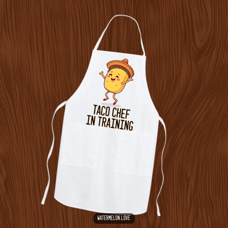 Funny apron featuring an anthropomorphic taco with legs dancing joyfully while wearing a sombrero, perfect for kitchen fun.